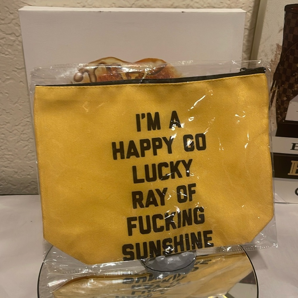 NWT POUCH ZIP CLUTCH. “I’m A Happy Go Lucky Ray of Sunshine” ☀️ New in Package.
